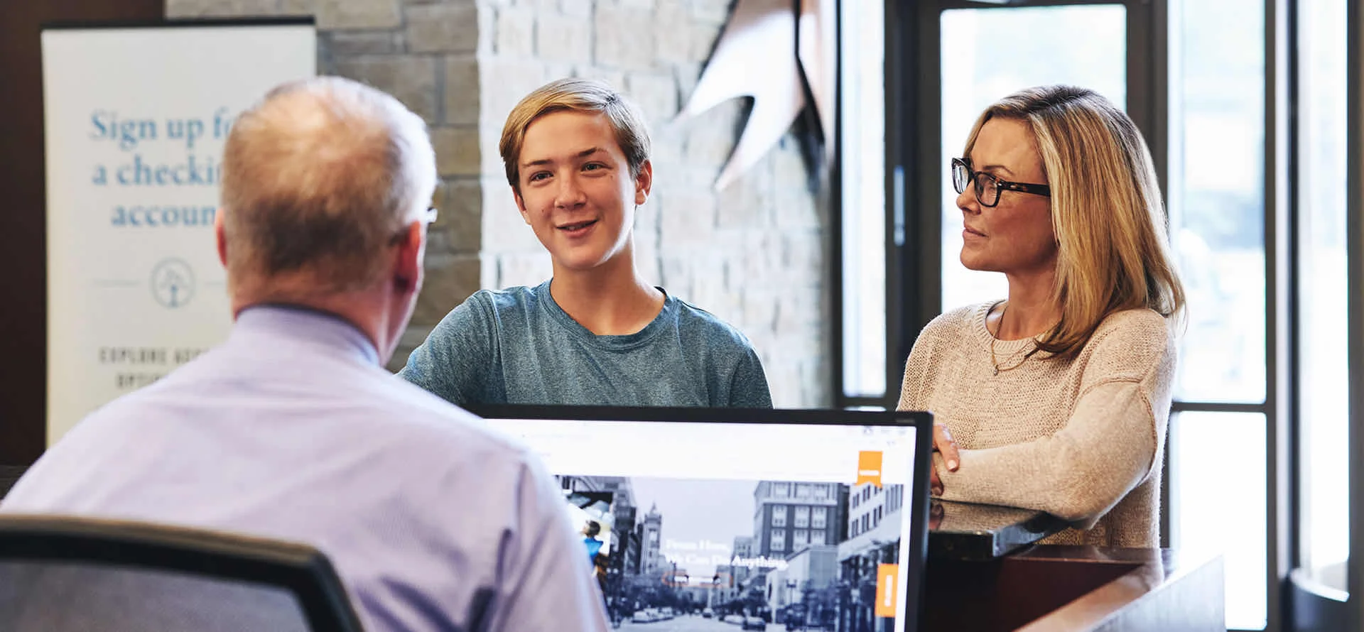 Woman with son talking to banker