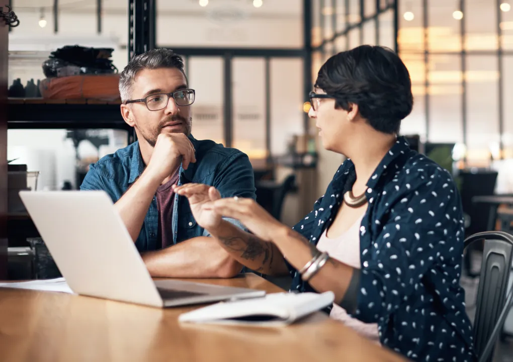 Colleagues discussing financial strategies in an office setting
