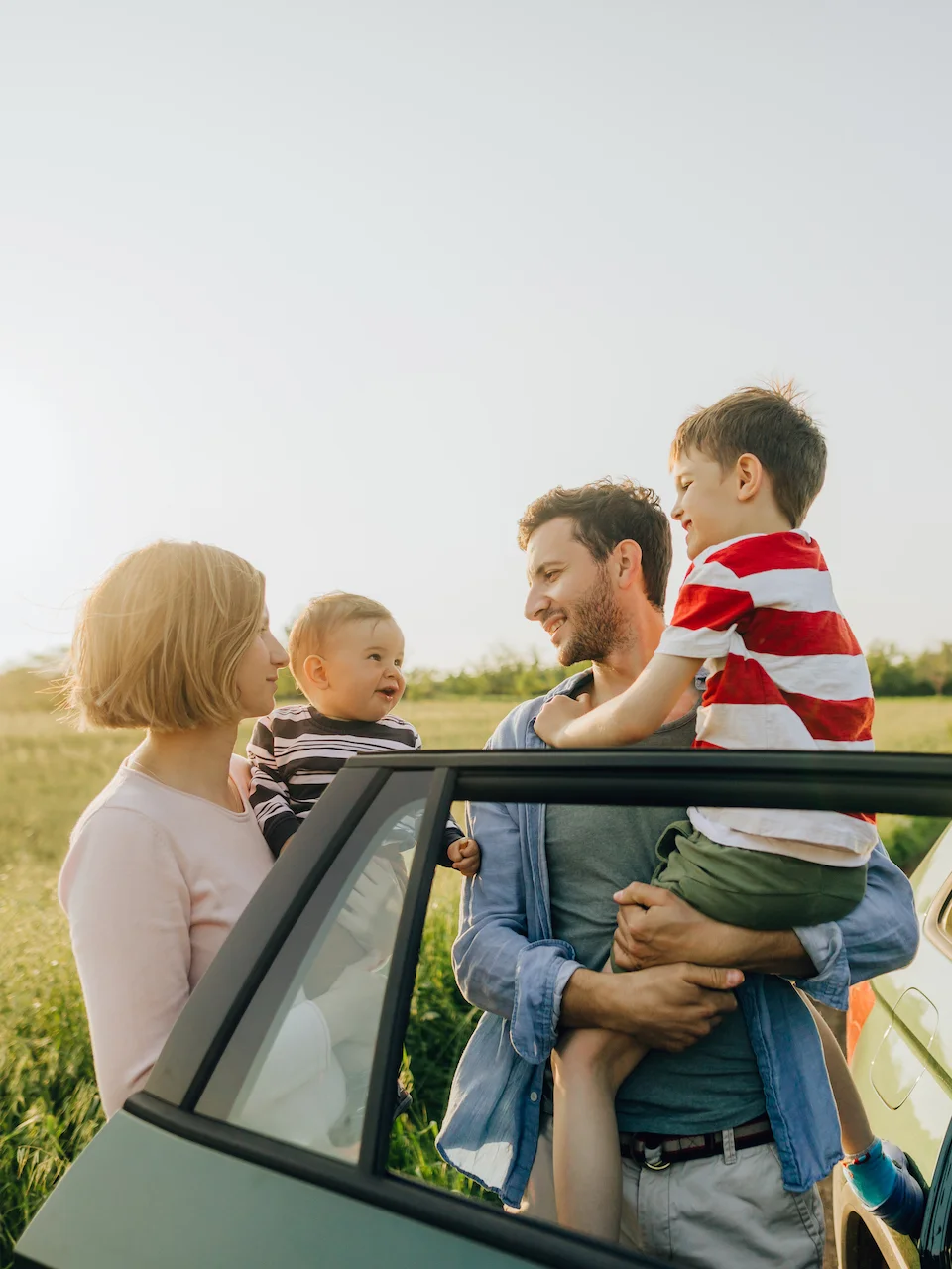Family smiling about purchase of new car