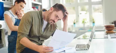 Frustrated man looking over finances