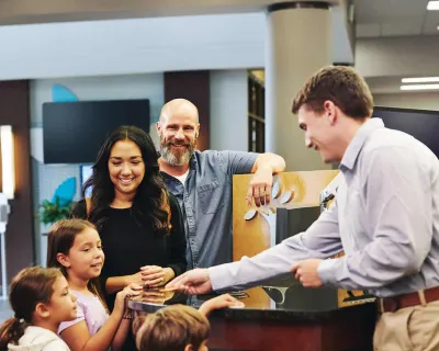 Family interacts with personal banker