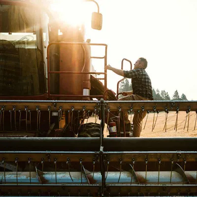 Man using combine in field