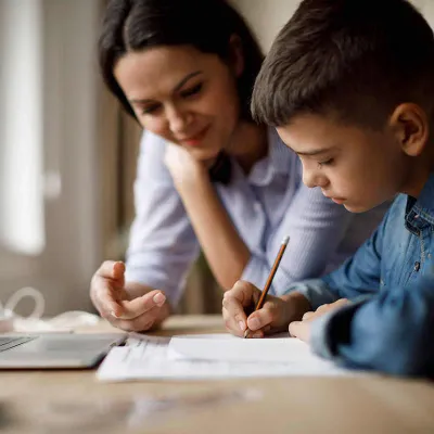 Mom helping son with homework