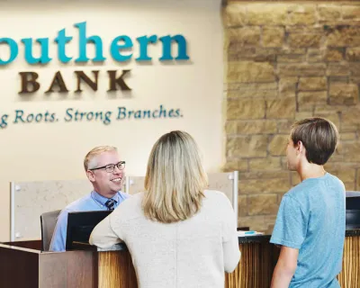 Woman and son working with personal banker.