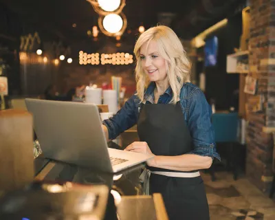 Restaurant owner working on computer