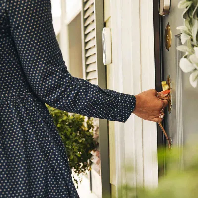 Woman opening front door