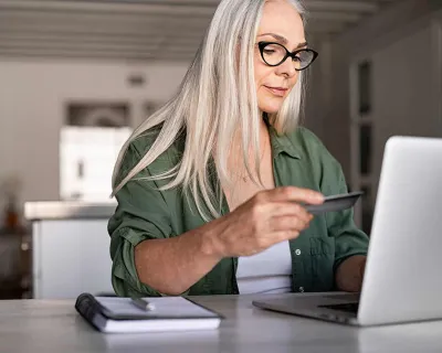 Woman using credit card online