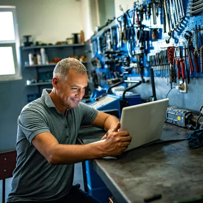Man working on computer in workshop